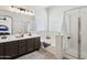 Bright bathroom features a double vanity, soaking tub, and separate glass-enclosed shower at 13724 W Luke Ave, Litchfield Park, AZ 85340