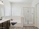 A well-lit bathroom shows a bathtub, separate shower, and vanity with modern fixtures at 13724 W Luke Ave, Litchfield Park, AZ 85340