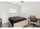 Cozy bedroom featuring a ceiling fan, window, and modern desk area at 13724 W Luke Ave, Litchfield Park, AZ 85340