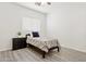 Bright bedroom with modern grey floors and a single bed at 13724 W Luke Ave, Litchfield Park, AZ 85340