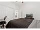 Bright bedroom featuring a ceiling fan, sliding door closet, and media center at 13724 W Luke Ave, Litchfield Park, AZ 85340