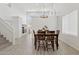 Bright dining room with a wooden table, six chairs, and modern light fixtures at 13724 W Luke Ave, Litchfield Park, AZ 85340