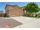 Spacious stucco home featuring a three-car garage, and ample driveway parking at 13724 W Luke Ave, Litchfield Park, AZ 85340