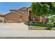 Two-story home with a three-car garage, neutral stucco, tile roof, and well-kept landscaping at 13724 W Luke Ave, Litchfield Park, AZ 85340