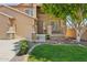 Inviting home with manicured lawn, mature tree, and charming front porch at 13724 W Luke Ave, Litchfield Park, AZ 85340