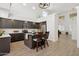 Bright kitchen with dark cabinets, island with seating, modern appliances, and lots of natural light at 13724 W Luke Ave, Litchfield Park, AZ 85340