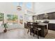 Kitchen with dark cabinetry, white countertops, a center island with bar seating, and a view of the pool at 13724 W Luke Ave, Litchfield Park, AZ 85340