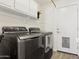 Modern laundry room with a sleek washer and dryer set and ample storage at 13724 W Luke Ave, Litchfield Park, AZ 85340