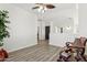 Cozy loft featuring a ceiling fan, comfortable seating, and bright natural light at 13724 W Luke Ave, Litchfield Park, AZ 85340