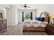 Relaxing main bedroom with a ceiling fan, king bed, and balcony access at 13724 W Luke Ave, Litchfield Park, AZ 85340
