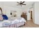 Stylish main bedroom with a ceiling fan, hardwood floors, and an ensuite bathroom at 13724 W Luke Ave, Litchfield Park, AZ 85340