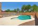 A fenced in pool with rock landscape, and a seating area at 13724 W Luke Ave, Litchfield Park, AZ 85340