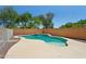 Beautiful backyard pool area with a waterfall feature and mature trees at 13724 W Luke Ave, Litchfield Park, AZ 85340