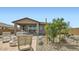 Charming backyard featuring a covered patio, outdoor seating, and a well-maintained garden at 1516 W Ridge Rd, Apache Junction, AZ 85120