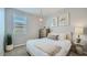 Inviting bedroom features a comfortable bed, stylish light fixture, and window at 1516 W Ridge Rd, Apache Junction, AZ 85120