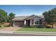 Charming single-story home featuring a neutral palette, paired garage and manicured lawn at 1516 W Ridge Rd, Apache Junction, AZ 85120