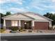 Charming single-story home featuring a two-car garage, landscaped front yard, and stone veneer accents at 15918 W El Cortez Pl, Surprise, AZ 85387