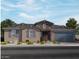 Charming single-story home with stone accents, a well-maintained yard, and a two-car garage at 15933 W El Cortez Pl, Surprise, AZ 85387