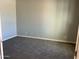 Clean, carpeted bedroom with light-colored walls, ready for customization and personalization at 16035 W Questa Dr, Surprise, AZ 85387