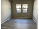 Bare bedroom with two windows and hard flooring at 16035 W Questa Dr, Surprise, AZ 85387