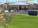 Community park featuring a playground, a covered pavilion, picnic tables, and green space at 16035 W Questa Dr, Surprise, AZ 85387