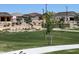 Scenic view of the neighborhood park with grassy areas and walking paths near new homes at 16035 W Questa Dr, Surprise, AZ 85387