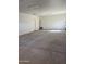 Spacious garage with concrete floor and white walls, ready for customization at 16035 W Questa Dr, Surprise, AZ 85387