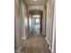 Inviting hallway with tile flooring, archways, and neutral paint, offering a seamless flow throughout the home at 16035 W Questa Dr, Surprise, AZ 85387