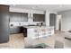 Modern kitchen boasting granite countertops, stainless steel appliances, and a central island with bar seating at 16035 W Questa Dr, Surprise, AZ 85387