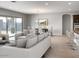 Modern living room featuring a comfortable couch, dining area, and large sliding glass doors at 16035 W Questa Dr, Surprise, AZ 85387