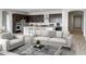 Bright living room features an open layout with an eat-in kitchen and sleek modern furniture at 16035 W Questa Dr, Surprise, AZ 85387