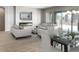 Open-concept living area with a fireplace, large windows, and ample space for dining and entertaining at 16035 W Questa Dr, Surprise, AZ 85387