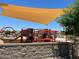 Community playground featuring a shade structure and an array of play equipment at 16035 W Questa Dr, Surprise, AZ 85387