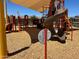 Vibrant community playground featuring slides, climbing frames, and a shaded area for to play at 16035 W Questa Dr, Surprise, AZ 85387