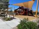 Playground featuring a slide and a play structure along with landscaping and a bench at 16035 W Questa Dr, Surprise, AZ 85387