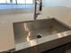 Close-up of a stainless steel kitchen sink with modern faucet on a countertop at 16035 W Questa Dr, Surprise, AZ 85387