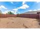 Large backyard with a sturdy brick fence, offering plenty of potential for landscaping and outdoor activities at 16221 W Prickly Pear Trl, Surprise, AZ 85387