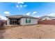Expansive backyard offering ample space for customization, with a covered patio and partial fencing at 16221 W Prickly Pear Trl, Surprise, AZ 85387