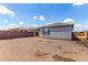 View of the backyard highlighting the house exterior and the expansive, undeveloped space surrounded by a brick fence at 16221 W Prickly Pear Trl, Surprise, AZ 85387