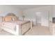 Neutral primary bedroom with light-colored carpet and an intricately designed bed frame at 16221 W Prickly Pear Trl, Surprise, AZ 85387