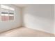 Minimalist bedroom with a window providing natural light and wall-to-wall carpet flooring at 16221 W Prickly Pear Trl, Surprise, AZ 85387