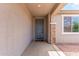 Inviting entryway featuring neutral walls, a decorative doormat, and a view of a window letting in natural light at 16221 W Prickly Pear Trl, Surprise, AZ 85387