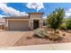 Charming single-story home featuring a stone facade, well-maintained landscaping, and a spacious two-car garage at 16221 W Prickly Pear Trl, Surprise, AZ 85387