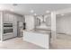 Modern kitchen with stainless steel appliances, gray cabinetry, and a functional island with granite countertops at 16221 W Prickly Pear Trl, Surprise, AZ 85387