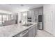 Modern kitchen with stainless steel appliances, gray cabinets, and spacious center island at 16221 W Prickly Pear Trl, Surprise, AZ 85387