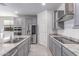 Updated kitchen featuring stainless appliances, gray cabinets, and modern fixtures at 16221 W Prickly Pear Trl, Surprise, AZ 85387