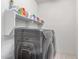 Convenient laundry room with modern appliances and shelving for storage and organization at 16221 W Prickly Pear Trl, Surprise, AZ 85387