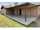 Spacious covered patio with stained concrete, surrounded by lush lawn in the backyard at 1714 W Villa Rita Dr, Phoenix, AZ 85023
