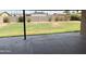 View of spacious backyard with grass, sparse landscaping, concrete patio, and block fence at 1714 W Villa Rita Dr, Phoenix, AZ 85023