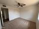 Bedroom featuring carpet, a closet, and a ceiling fan at 1714 W Villa Rita Dr, Phoenix, AZ 85023